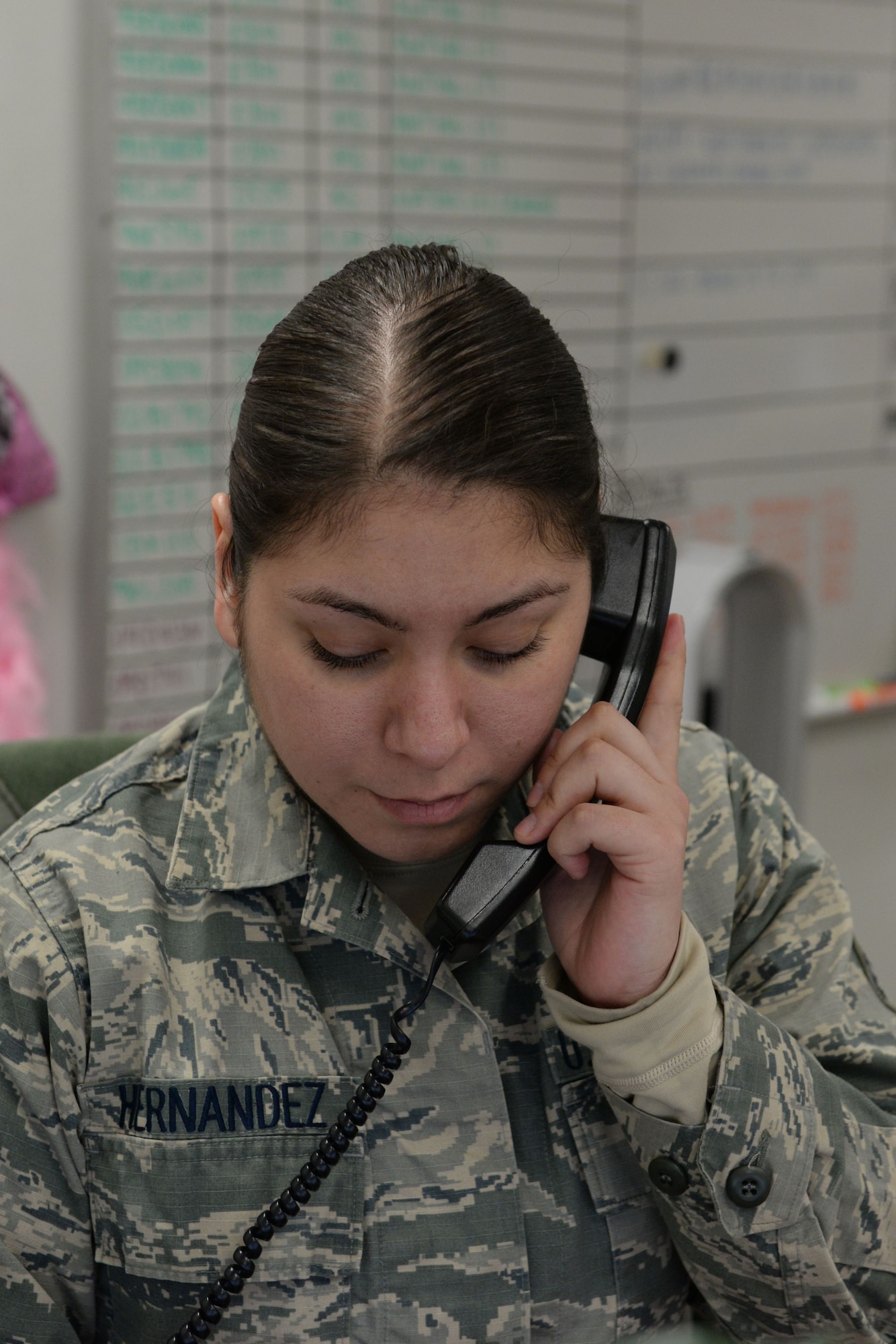 Senior Airman Mitzy Hernandez, journeyman with the 673d Logistics Readiness Squadron Vehicle Maintenance, Fleet Management and Analysis shop, speaks to a customer on the telephone, Jan. 25, 2018, at Joint Base Elmendorf-Richardson, Alaska. FMNA maintains record jackets and maintenance schedules for all vehicle accounts in addition to opening and closing work orders for the vehicles customers bring in for maintenance.