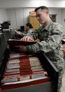 Airman Matthew Tracy and Airman 1st Class Maria Preciado, apprentices with the 673d Logistics Readiness Squadron Vehicle Maintenance, Fleet Management and Analysis shop, audit vehicle record jacket files, Jan. 25, 2018, at Joint Base Elmendorf-Richardson, Alaska. FMNA maintains record jackets and maintenance schedules for all vehicle accounts in addition to opening and closing work orders for the vehicles customers bring in for maintenance.