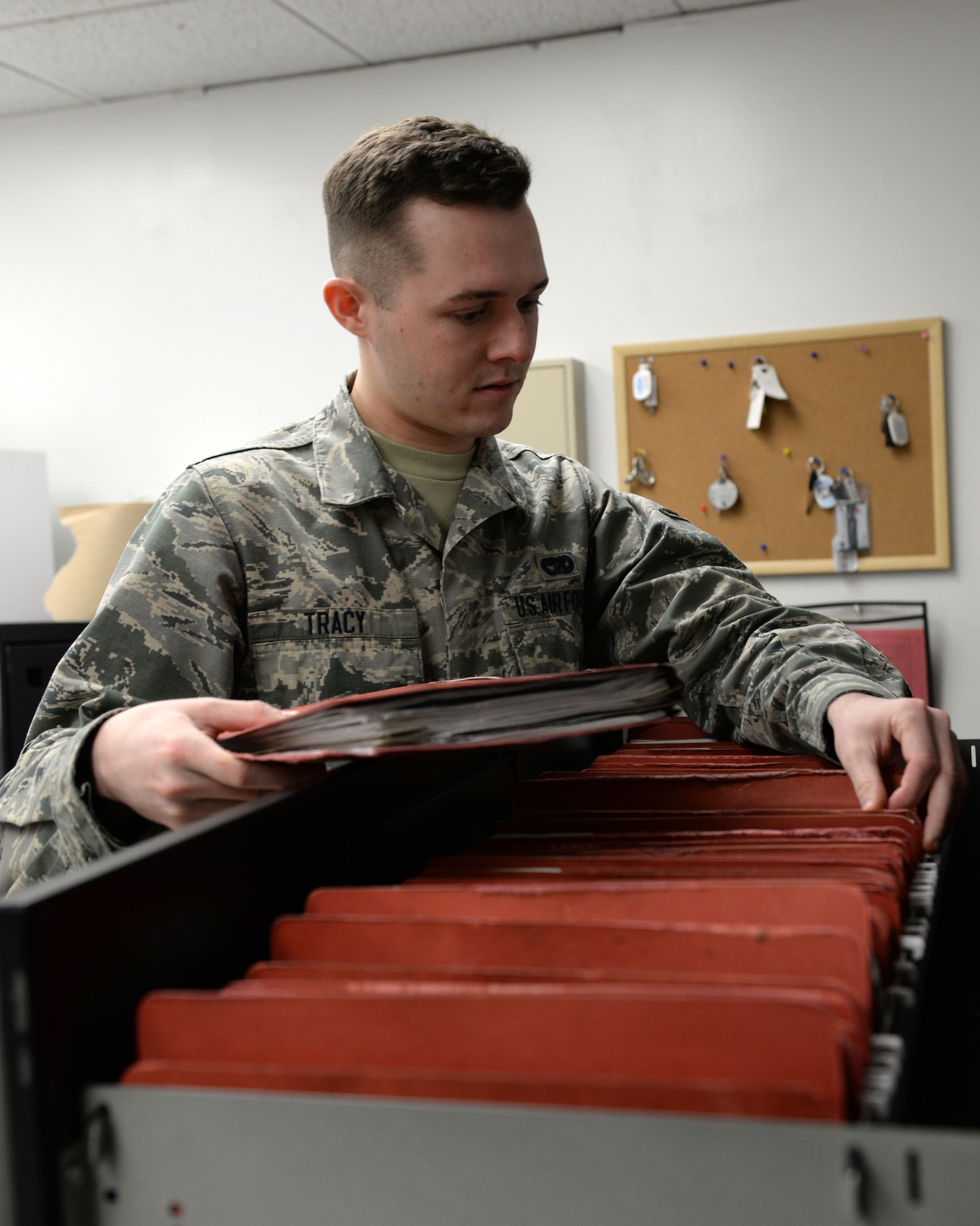 Airman Matthew Tracy, apprentice with the 673d Logistics Readiness Squadron Vehicle Maintenance, Fleet Management and Analysis shop, audit vehicle record jacket files, Jan. 25, 2018, at Joint Base Elmendorf-Richardson, Alaska. FMNA maintains record jackets and maintenance schedules for all vehicle accounts in addition to opening and closing work orders for the vehicles customers bring in for maintenance.