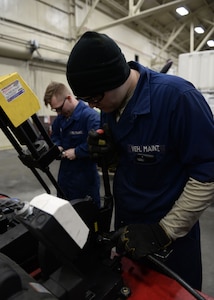 Senior Airman Jacob Holst, mission general vehicle equipment maintenance journeyman with the 673d Logistics Readiness Squadron Vehicle Maintenance, Flightline Maintenance shop, cuts rubber tubing for a hydraulic hose, Jan. 25, 2018, at Joint Base Elmendorf-Richardson, Alaska. Flightline maintenance repairs and services all of the Global deicer trucks, Caterpillar 50K forklifts lifts, 60K aircraft cargo loader/transporters and Grove MB-2 aircraft tug/pushback tractors used for flightline operations.