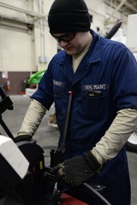 Senior Airman Jacob Holst, mission general vehicle equipment maintenance journeyman with the 673d Logistics Readiness Squadron Vehicle Maintenance, Flightline Maintenance shop, cuts rubber tubing for a hydraulic hose, Jan. 25, 2018, at Joint Base Elmendorf-Richardson, Alaska. Flightline maintenance repairs and services all of the Global deicer trucks, Caterpillar 50K forklifts lifts, 60K aircraft cargo loader/transporters and Grove MB-2 aircraft tug/pushback tractors used for flightline operations.