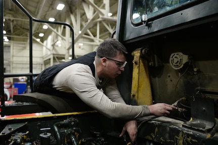 Airman 1st Class Spencer Ludlow, mission general vehicle equipment maintenance apprentice with the 673d Logistics Readiness Squadron Vehicle Maintenance, Flightline Maintenance shop, connects a wire harness on a 50K forklift, Jan. 25, 2018, at Joint Base Elmendorf-Richardson, Alaska. Flightline maintenance repairs and services all of the Global deicer trucks, Caterpillar 50K forklifts lifts, 60K aircraft cargo loader/transporters and Grove MB-2 Aircraft tug/pushback tractors used for flightline operations.