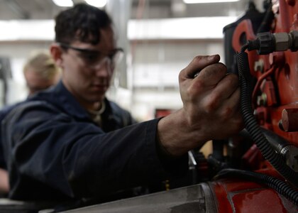 Airman 1st Class Nicholas Johnston, fire truck maintenance apprentice with the 673d Logistics Readiness Squadron Vehicle Maintenance, Fire Truck Maintenance shop, changes a coolant hose on a fire truck, Jan. 25, 2018, at Joint Base Elmendorf-Richardson, Alaska. The Fire Truck Maintenance shop repairs and services all fire trucks at JBER.