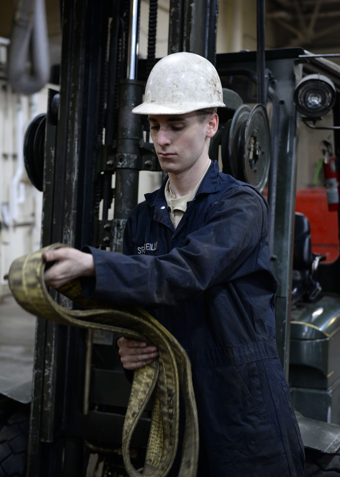 Senior Airman Samuel Reilly, a mission general vehicle equipment maintenance journeyman, with the 673d Logistics Readiness Squadron Vehicle Maintenance, Heavy Equipment shop, organizes tie-straps used for hoisting, Jan. 25, 2018, at Joint Base Elmendorf-Richardson, Alaska. The Heavy Equipment shop repairs and services all snow-removal and road equipment at JBER.