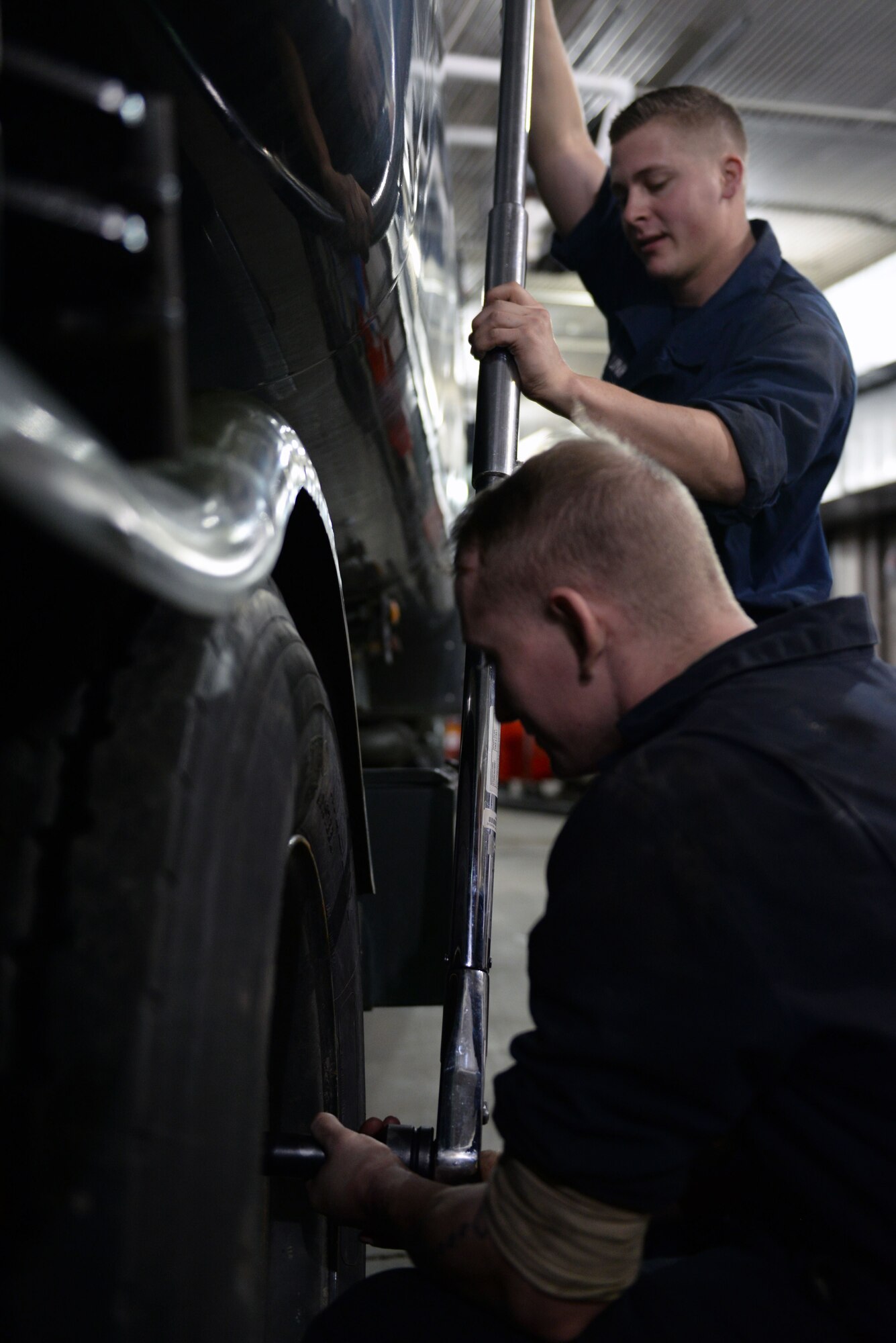 Senior Airman Blade LeJeune and Senior Airman Samuel Unke, mission general vehicle equipment maintenance journeymen with the 673d Logistics Readiness Squadron Vehicle Maintenance, Refueling Maintenance shop, tighten the lug nuts on an R-11, Jan. 26, 2018, at Joint Base Elmendorf-Richardson, Alaska. The Refueling Maintenance shop repairs and services all refueling equipment such as the R-11 and R-12 at JBER.