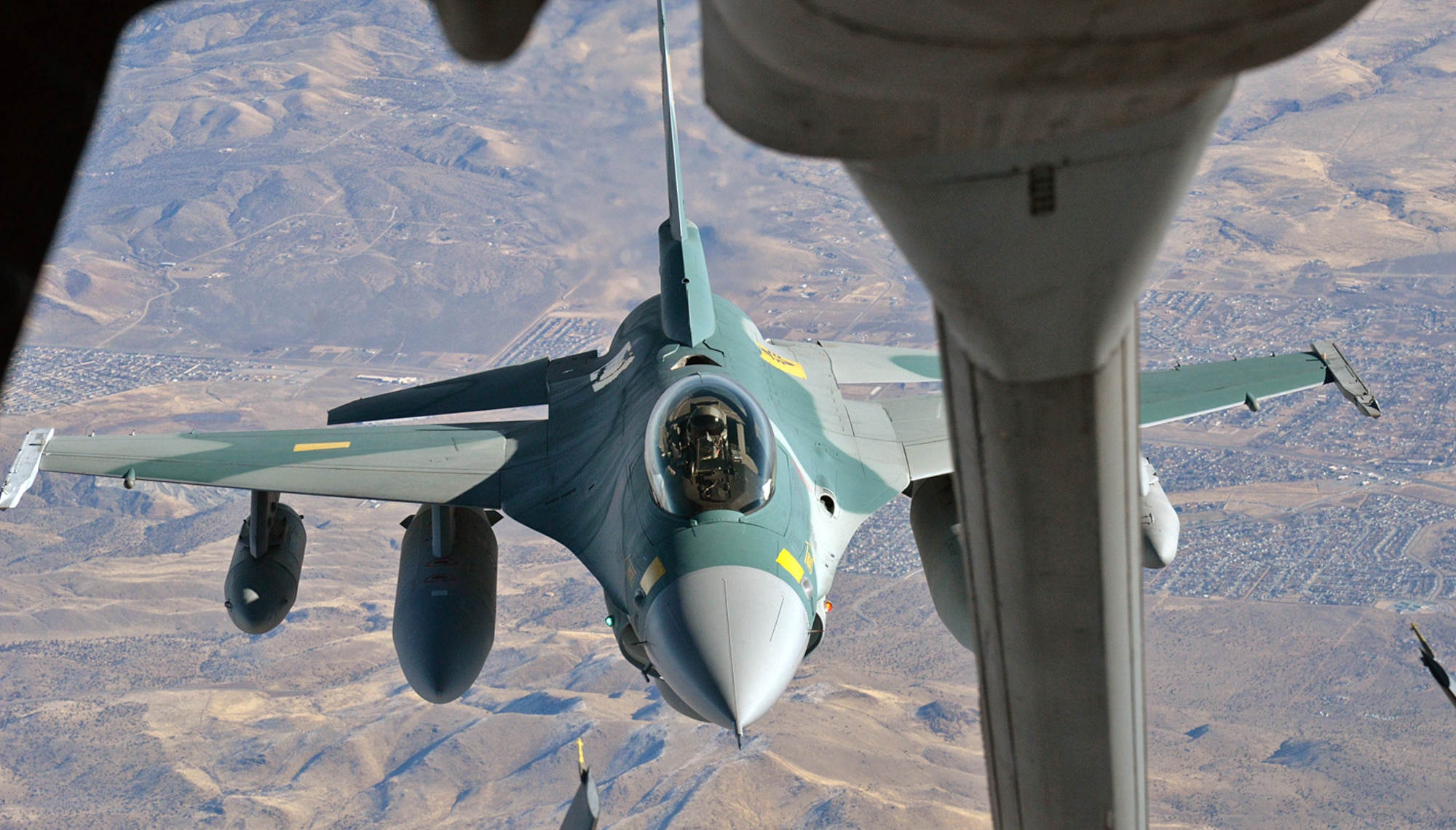 Over Sun Valley, Nevada, Arizona National Guard pilot, Lt. Col. Gregory “Ajax” Gaff, positions his Indonesian F-16C behind a KC-10 Extender aerial refueling aircraft in preparation to receive fuel during a ferry flight from Hill Air Force Base, Utah, to Hickam AFB, Hawaii, on Dec. 6, 2017. The aircraft was fitted with three external tanks and be refueled several times during the six-and-a-half hour flight. (U.S. Air Force photo by Alex R. Lloyd)