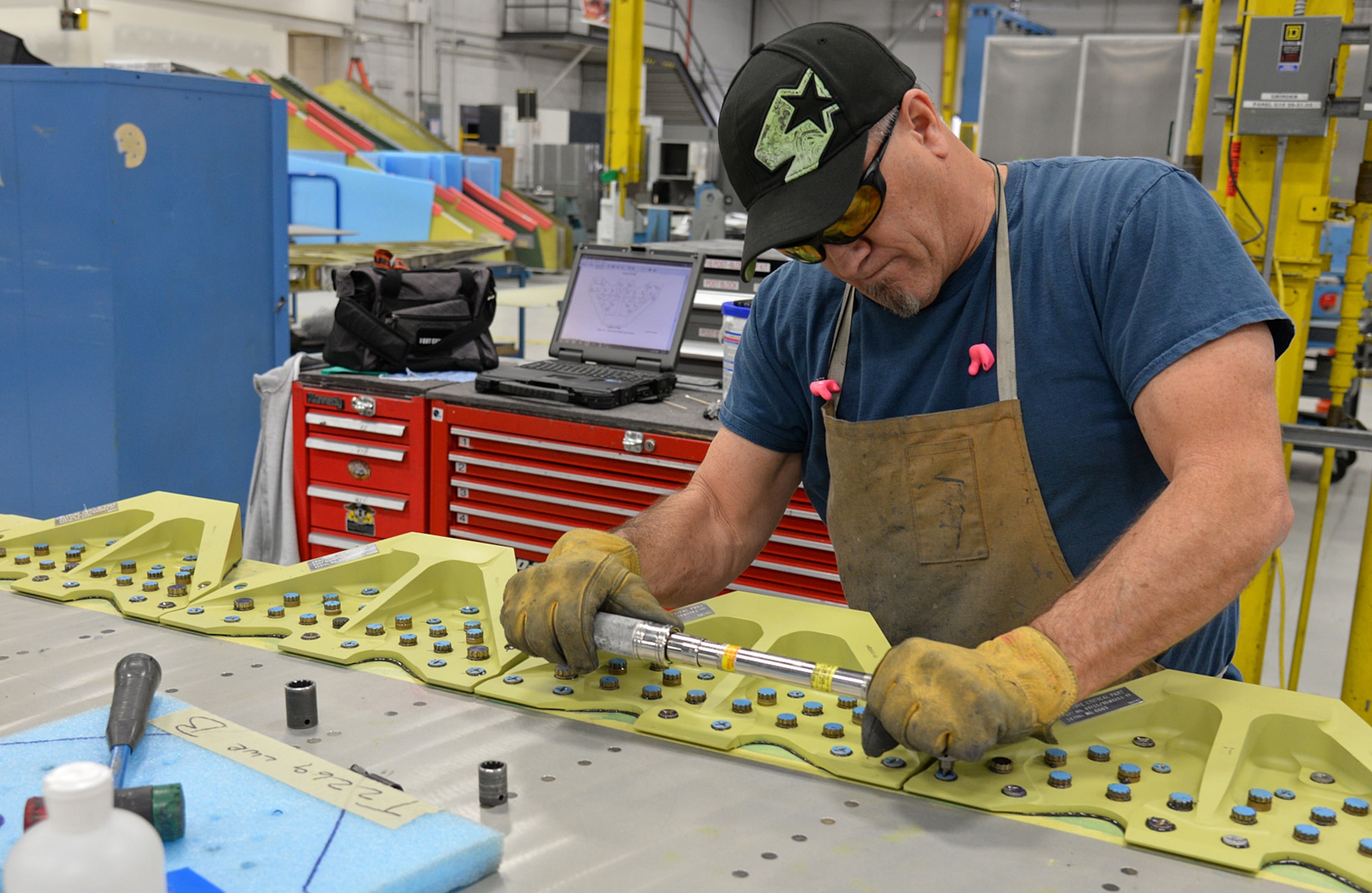 Using his brute strength, Brian Grose, 533rd Commodities Maintenance Squadron, torques down screws that hold wing attach fittings to a reconditioned F-16 wing on Jan. 9, 2018 at Hill Air Force Base, Utah. Wing overhauls are one of many forms of maintenance performed by different Ogden Air Logistics Complex Complex organizations that keep F-16s flying in the skies of northern Utah and around the world. (U.S. Air Force photo by Alex R. Lloyd)