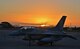 An Indonesian F-16 sits on the tarmac at Hickam Air Force Base, Hawaii, with the sun rising over Diamond Head and downtown Honolulu on Pearl Harbor Day, Dec. 7, 2017. U.S. Air Force Air National Guard pilots along with maintainers from the Ogden Air Logistics Complex spent several days getting six regenerated F-16s from Utah to Indonesia.  (U.S. Air Force photo by Alex R. Lloyd)