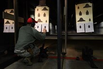 U.S. Air Force Staff Sgt. David Ward, 20th Security Forces Squadron combat arms instructor, evaluates a student’s target during an M4 carbine qualification course at Shaw Air Force Base, S.C., Jan. 25, 2018.