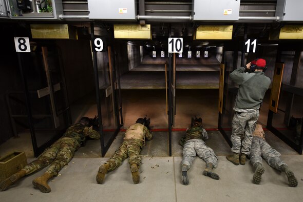 U.S. Airmen shoot targets during an M4 carbine qualification course while a 20th Security Forces Squadron combat arms instructor observes at Shaw Air Force Base, S.C., Jan. 25, 2018.