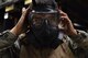 A U.S. Airmen puts on a gas mask during an M4 carbine qualification course at Shaw Air Force Base, S.C., Jan. 25, 2018.