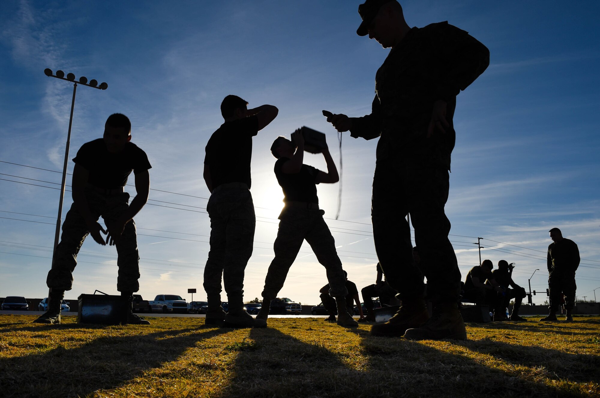 Marines are timed while performing an ammo can lift during a combat fitness test challenge at Luke Air Force Base, Ariz., Jan. 26, 2018. The challenge was held between Marines and Airmen to build esprit de corps between the two services. During the CFT, a 30 pound ammo can is lifted above the head as many times possible in two minutes. (U.S. Air Force photo/Staff Sgt. Jensen Stidham)