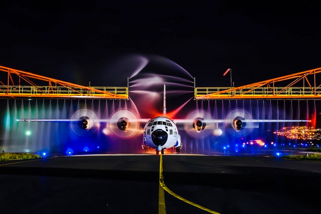 A Coast Guard HC-130 Hercules airplane receives a wash down.