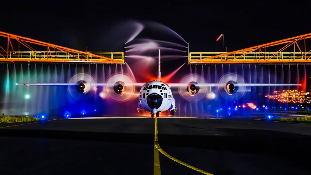 A Coast Guard HC-130 Hercules airplane receives a wash down.