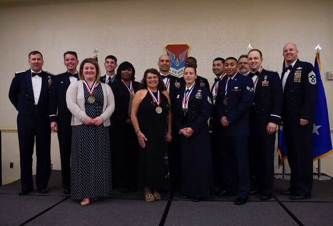 The annual award winners of the 628th Air Base Wing stand with Maj. Gen. Christopher J. Bench, U.S. Air Force Expeditionary Center commander far left, Col. Jeff Nelson, 628th ABW commander, second to left, and Chief Master Sgt. Todd Cole, 628th ABW command chief during an annual awards ceremony at the Charleston Club, Joint Base Charleston, S.C., Jan. 26, 2017.