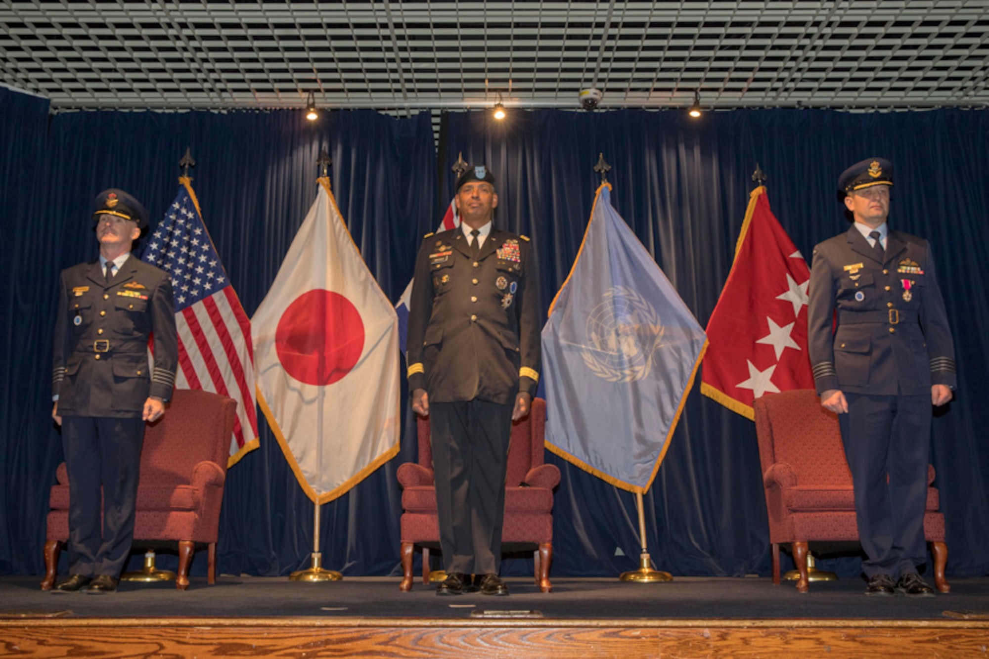 Royal Australian Air Force Group Captain Adam Williams, incoming United Nations Command (Rear) commander, U.S. Army General Vincent K. Brooks, United Nations Command, Combined Forces Command and U.S. Forces Korea commanding general stand in attention during a change of command ceremony
