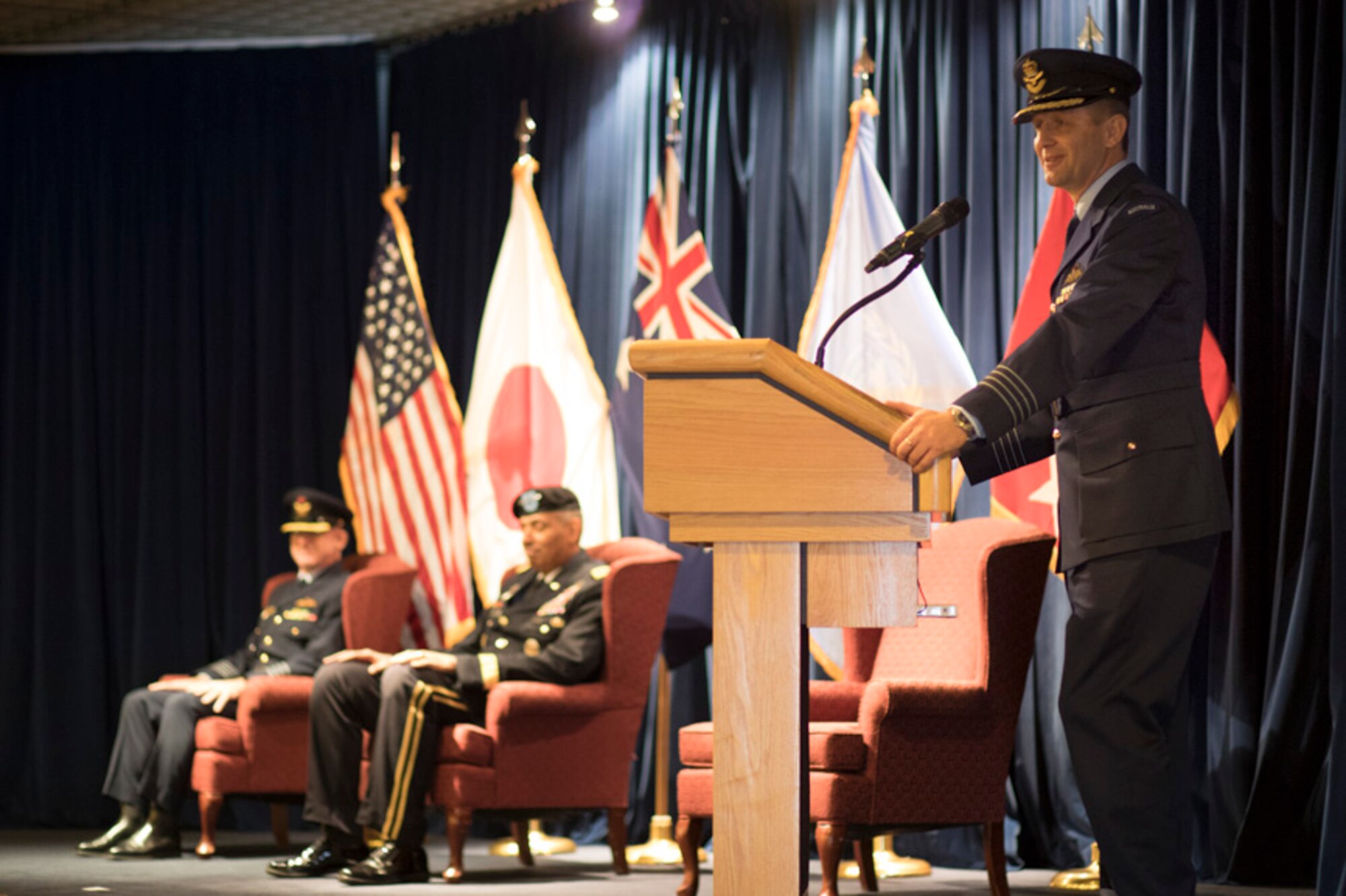 Royal Australian Air Force Group Captain Michael W. Jansen, outgoing United Nations Command (Rear) commander, gives his final speech during the UNC (Rear) change of command ceremony