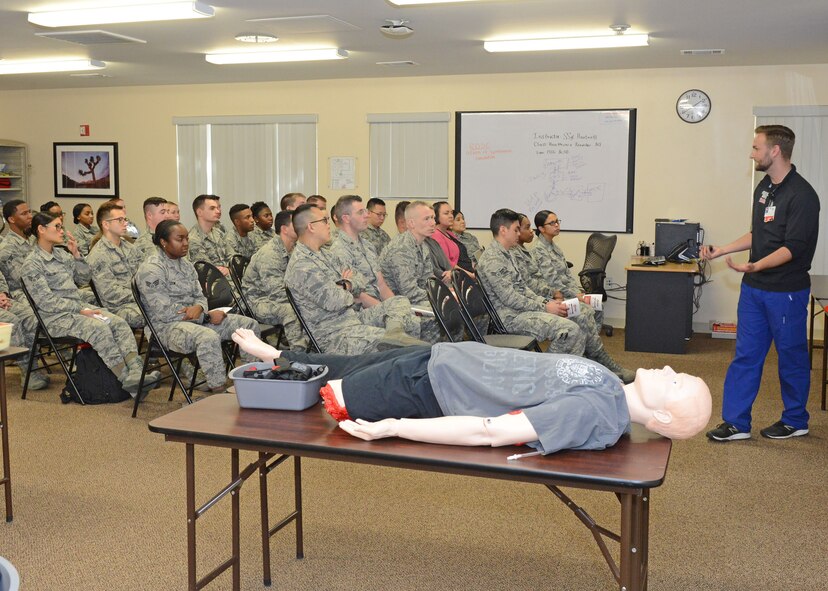 Maj. Joshua Wilson, 412th Medical Operations Squadron (right), applies a commercially bought tourniquet to a dummy during a special training event Jan. 29 at the 412th Medical Group Education and Training building. (U.S. Air Force photo by Kenji Thuloweit)
