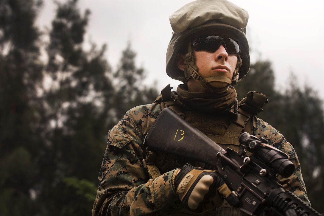 Marine Corps Lance Cpl. Nathon Peterson provides security while awaiting follow on orders.