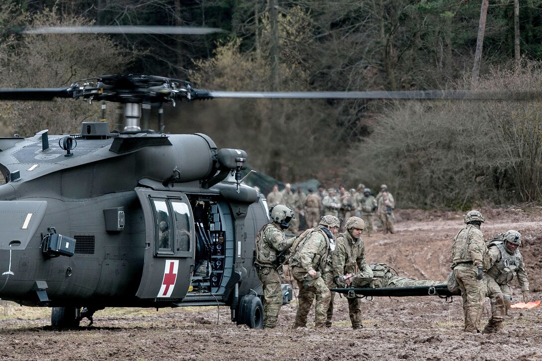 Army medics evacuate a patient from a helicopter during a training exercise in Germany.