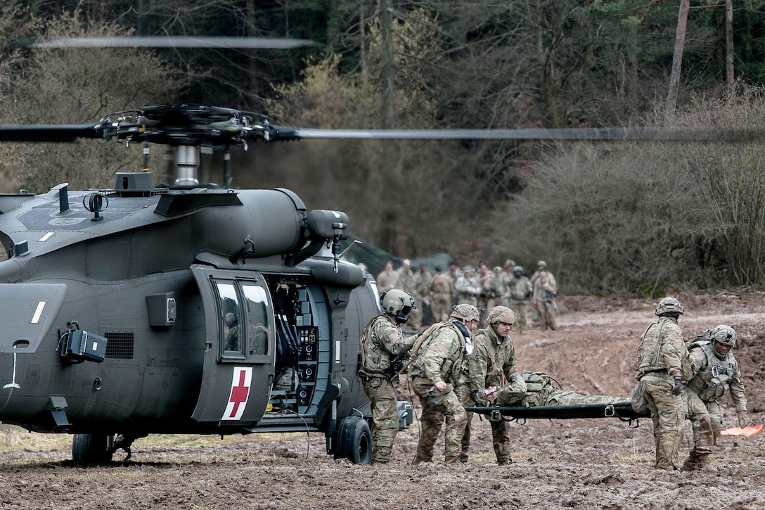 Army medics evacuate a patient from a helicopter during a training exercise in Germany.