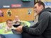 Infants from the Child Development Center East listen to Amn. Jason Keller, with the 552nd Maintenance Squadron as he reads them a book.