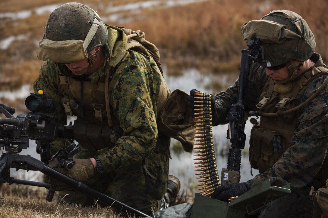 Marine prepare an M240 machine gun during exercise.