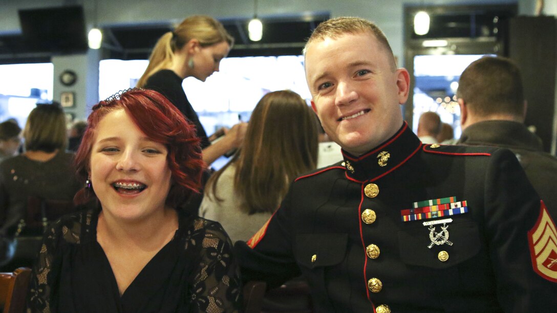 A Marine sitting with his date in a restaurant.