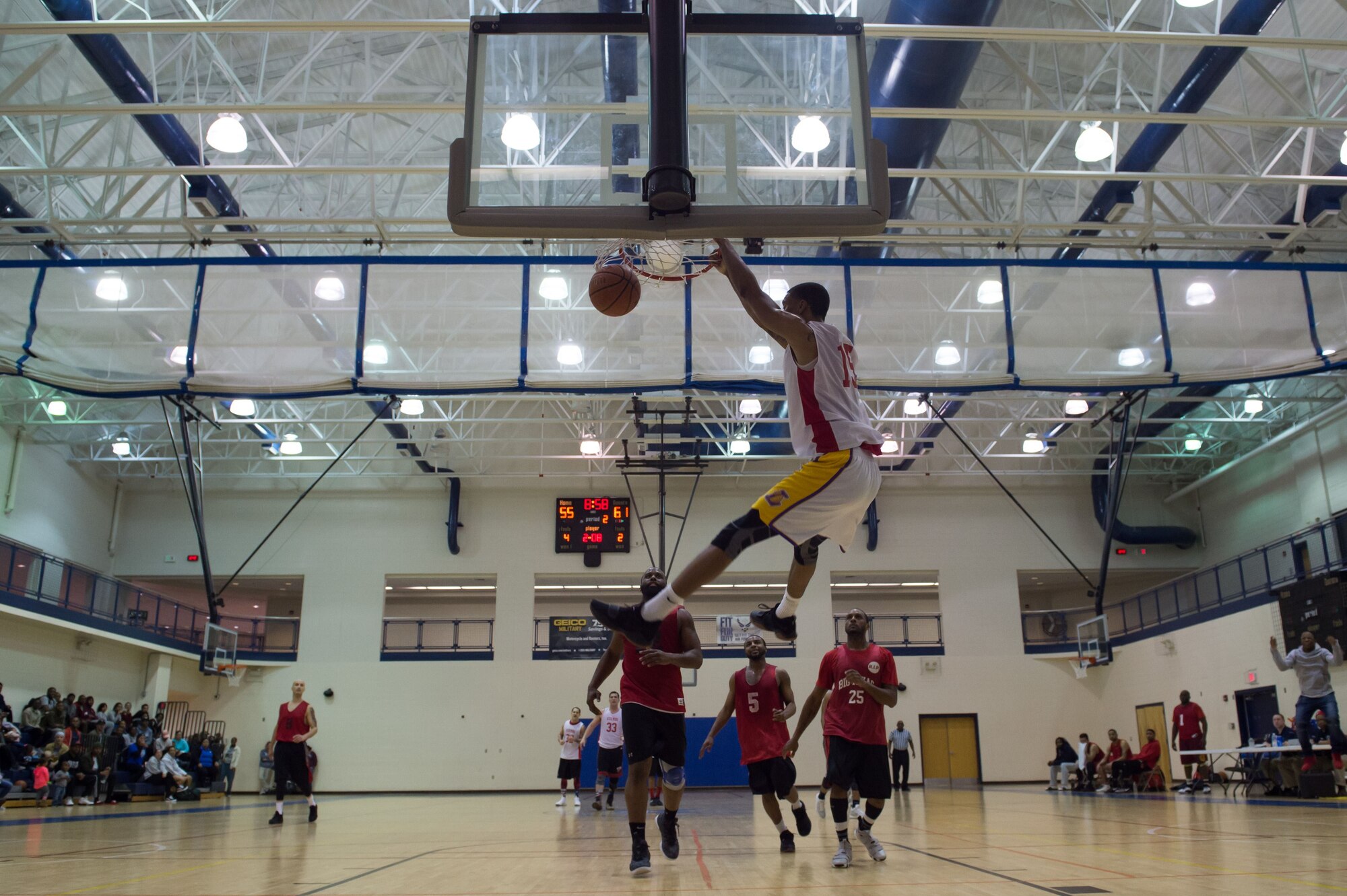 U.S. Air Force Staff Sgt. Brandon Tolson, 633 Medical Group NCO in charge of the MRI department, dunks a basketball during the intermural basketball championship game at the Shellbank Fitness Center, Joint Base Langley-Eustis, Va., Jan. 25, 2018.