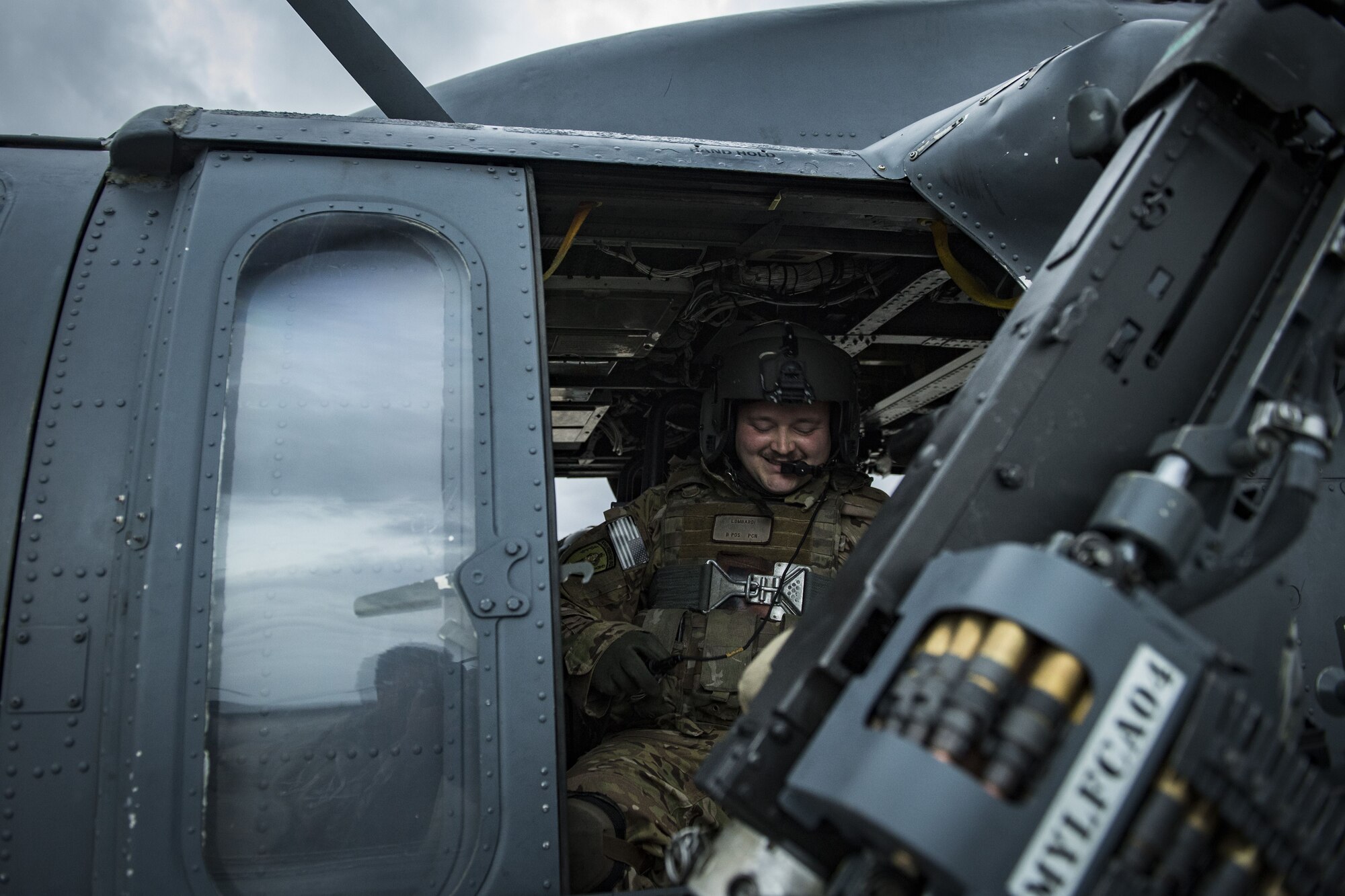 Senior Airman Joseph Lombardi, 41st Rescue Squadron special missions aviator, smiles while adjusting his gear, Jan. 22, 2018, at Moody Air Force Base, Ga. The 41st RQS is responsible for maintaining combat-ready personnel for recovery missions. To achieve this, members of the squadron constantly train on day and nighttime operations to maintain proficiency. (U.S. Air Force photo by Senior Airman Janiqua P. Robinson)