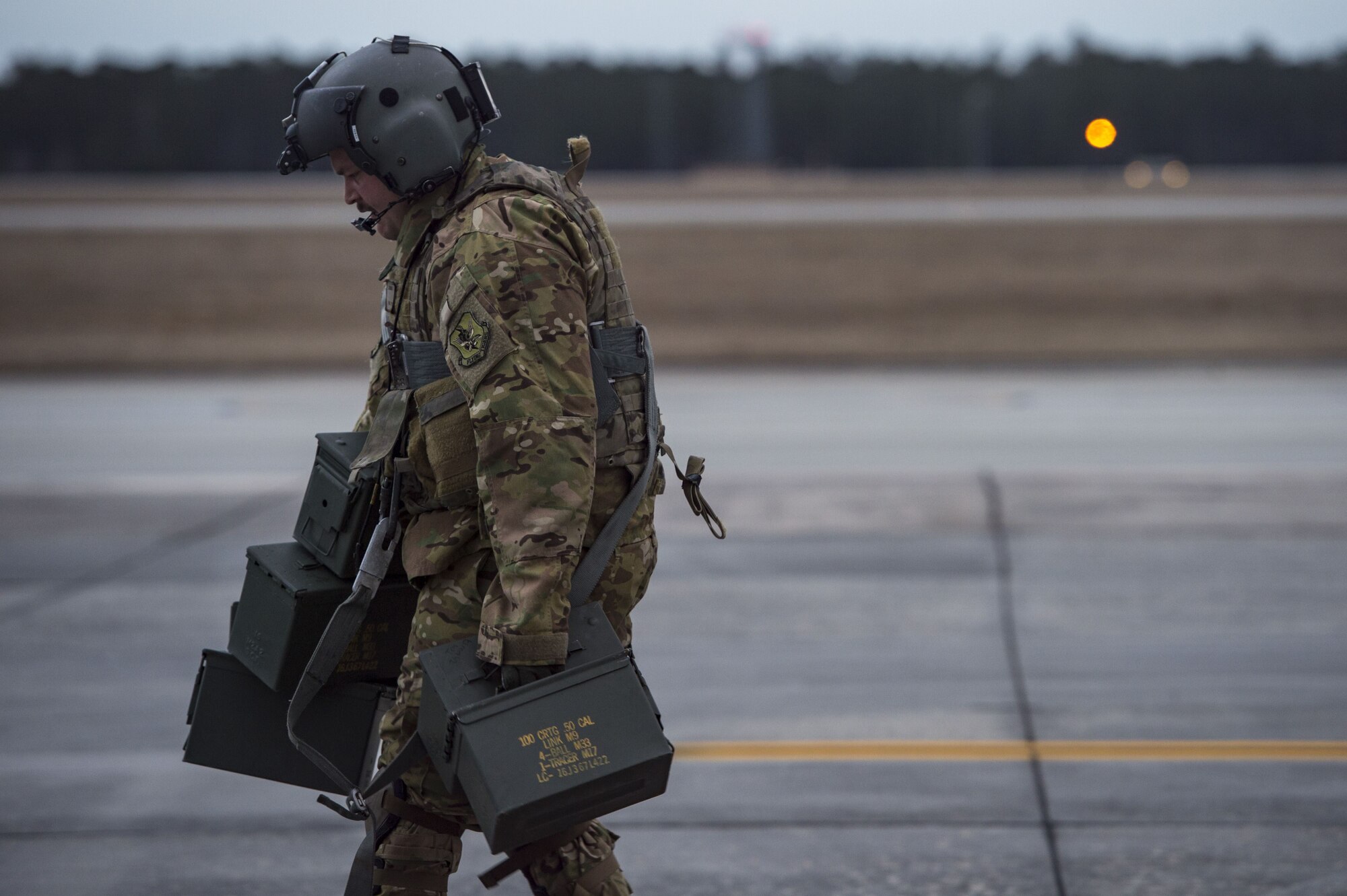 Senior Airman Joseph Lombardi, 41st Rescue Squadron (RQS) special missions aviator, carries empty ammunition cans, Jan. 22, 2018, at Moody Air Force Base, Ga.The 41st RQS is responsible for maintaining combat-ready personnel for recovery missions. To achieve this, members of the squadron constantly train on day and nighttime operations to maintain proficiency. (U.S. Air Force photo by Senior Airman Janiqua P. Robinson)