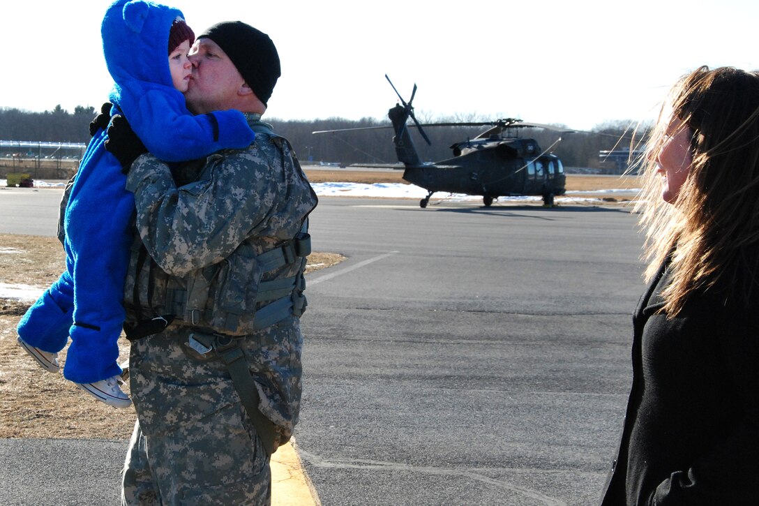 An Army pilot greets his grandson after completing his final flight.