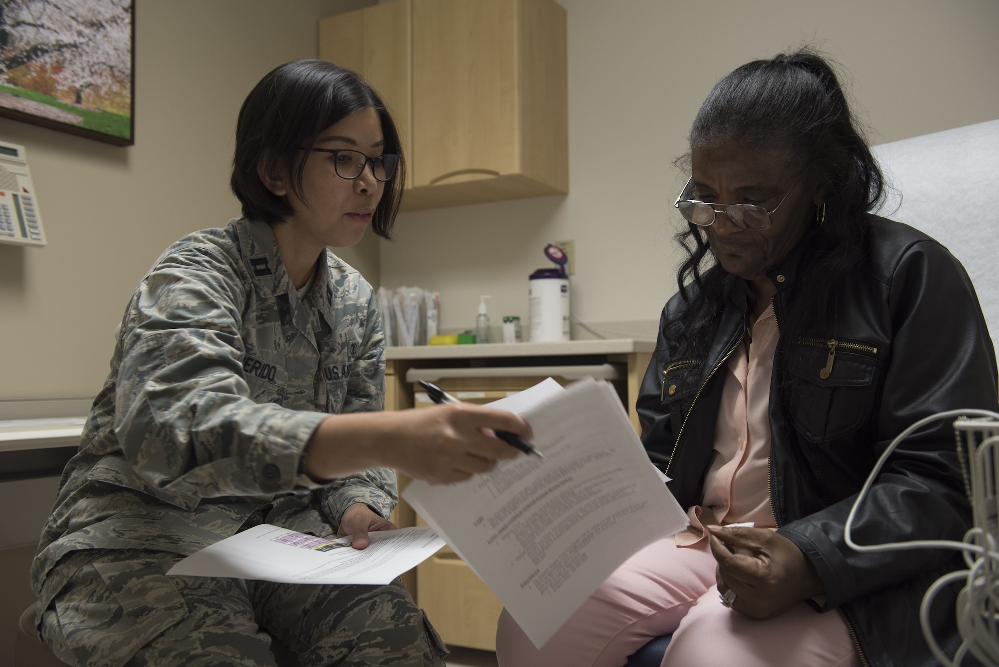Capt. Janice Perido, 60th Medical Group Surgical Squadron bariatric surgery physician assistant, explains the six month follow up report to Sharon L. Burton, bariatric patient Jan. 25, 2018, at a bariatric surgery waiting room at David Grant USAF Medical Center at Travis Air Force Base, California. Burton had a gastro bypass in July of 2017, and has currently lost 68 percent of her body mass index. (U.S. Air Force photo by Airman 1st Class Jonathon D. A. Carnell)