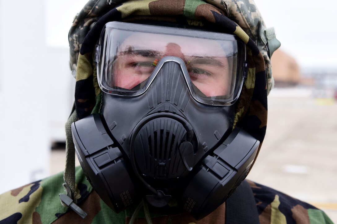 An airman wearing a gas mask.