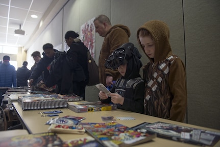 Families pick and choose two free single-issue comics from as old as the 1989 Gilgamesh II to 2015’s Paper Girls at the Joint Base Elmendorf-Richardson Library 4th Annual Comic Con, Jan. 27, 2018. The event included cosplay, a trivia contest, arts and crafts, and many more activities.