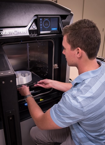 SPAWAR Systems Center (SSC) Atlantic employee Lucas Powell removes a finished part from a 3D printer. By using Additive Manufacturing technology, SSC Atlantic engineers and scientists can design and create prototypes for new components and replacement parts, and enhance and modify existing products. SSC Atlantic develops, acquires and provides life cycle support for command, control, communications, computer, intelligence, surveillance and reconnaissance (C4ISR) systems, information technology and space capabilities. A leading-edge Navy engineering center, SSC Atlantic designs, builds, tests, fields and supports many of the finest frontline C4ISR systems in use today, and those being planned for the future.