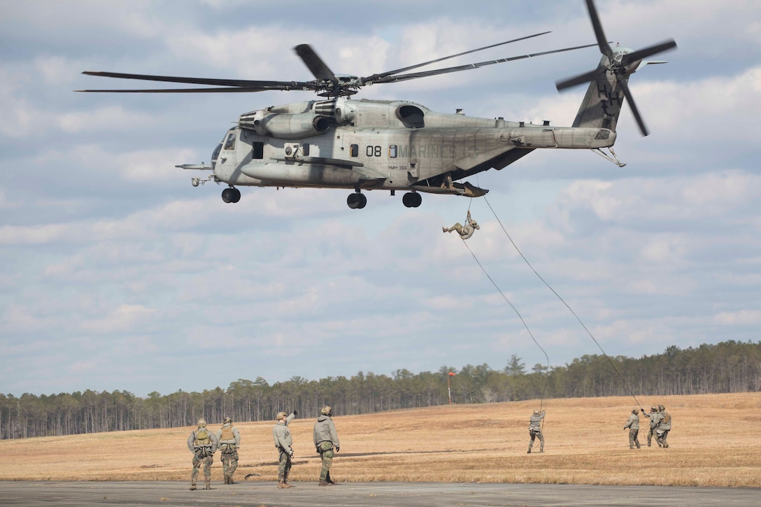 Marines with U.S. Marine Corps Forces, Special Operations Command conduct Special Patrol Insertion/Extraction techniques with the aid of a Marine Corps CH-53E Super Stallion helicopter in Camp Lejeune, N.C., Jan. 30, 2018.  Marines from 3rd Marine Raider Battalion completed SPIE training as part of MARSOF Helicopter Insert Extraction Techniques and Para Operations pre-deployment training requirements. (U.S. Marine Corps photo by Cpl. Bryann K. Whitley)