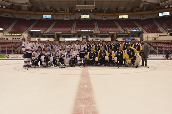 Members of the Charleston Patriots and Charleston Enforcers stand together during the Fourth Annual Deputy Joe Matuskovic Memorial Hockey Game at the North Charleston Coliseum, Jan. 27, 2018.
