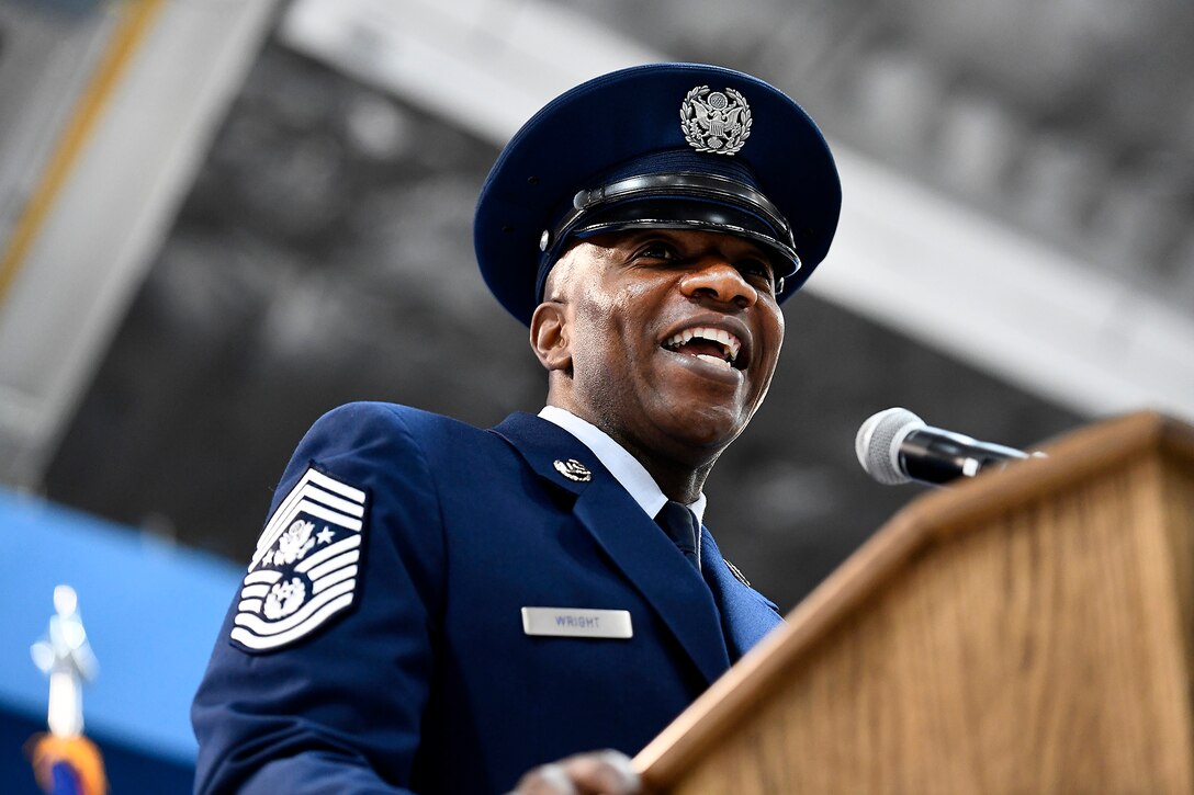 An Air Force leader stands behind a podium while giving remarks.