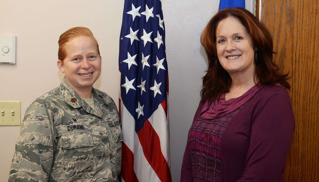 Maj. Michelle Durand, the 28th Force Support Squadron commander, and Reva Fleming, the 28th Bomb Wing chief of manpower and organization, stand by the U.S. flag at Ellsworth Air Force Base, S.D., Jan. 30, 2018. Ellsworth AFB won the Verne Orr award at the Air Force Global Strike Command level and will now compete at the Air Force level. (U.S. Air Force photo by Airman 1st Class Thomas Karol)