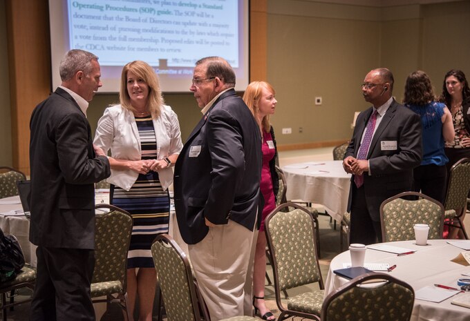The Deputy Director for Space and Naval Warfare Systems Center (SSC) Atlantic’s Office of Small Business Programs (OSBP) Robin Rourk (2nd from left), speaks with attendees at the Charleston Defense Contractors Association’s 46th quarterly Small Business and Industry Outreach Initiative (SBIOI) Symposium. Small business partnerships play a crucial role in SSC Atlantic’s agile and innovative support of warfighter missions. SSC Atlantic develops, acquires and provides life cycle support for command, control, communications, computer, intelligence, surveillance and reconnaissance (C4ISR) systems, information technology and space capabilities. A leading-edge Navy engineering center, SSC Atlantic designs, builds, tests, fields and supports many of the finest frontline C4ISR systems in use today, and those being planned for the future.