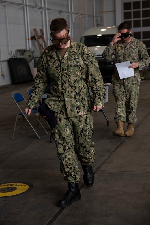 U.S. Navy Lt. Justin Van Es, the Naval Oceanography Antisubmarine Detachment Misawa officer in charge, wears Fatal Vision goggles while attempting to walk a straight line during the 75th Safety Convention held at Misawa Air Base, Japan, May 24, 2018. The facilitated training engaged participants in interactive exercises demonstrating the impairment effects of alcohol misuse. (U.S. Air Force photo by Airman 1st Class Collette Brooks)