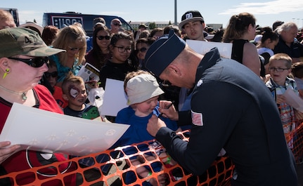 U.S. Air Force Lt. Col. Kevin Walsh, Thunderbird 1 with the U.S. Air Force Thunderbirds commander, signs a fan’s T-shirt after a performance at the Arctic Thunder Open House at Joint Base Elmendorf-Richardson, Alaska, July 1, 2018. During the biennial open house, JBER opens its gates to the public and hosts multiple performers including the U.S. Air Force Thunderbirds, JBER Joint Forces Demonstration and the U.S. Air Force F-22 Raptor Demonstration Team.