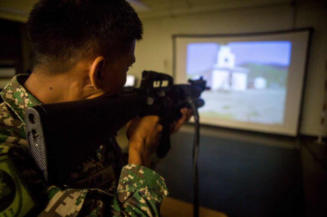 180630-M-ZO893-1044 MARINE CORPS BASE HAWAII (June 30, 2018) An Indonesian Marine fires a stimulated M16A4 assault rifle at an indoor simulated marksmanship trainer during Rim of the Pacific (RIMPAC) on Marine Corps Base Hawaii June 30, 2018. RIMPAC provides high-value training for task-organized, highly-capable Marine Air-Ground Task Force and enhances the critical crisis response capability of U.S. Marines in the Pacific. Twenty-five nations, 46 ships, five submarines, about 200 aircraft and 25,000 personnel are participating in RIMPAC from June 27 to Aug. 2 in and around the Hawaiian Islands and Southern California. (U.S. Marine Corps photo by Sgt. Zachary Orr)