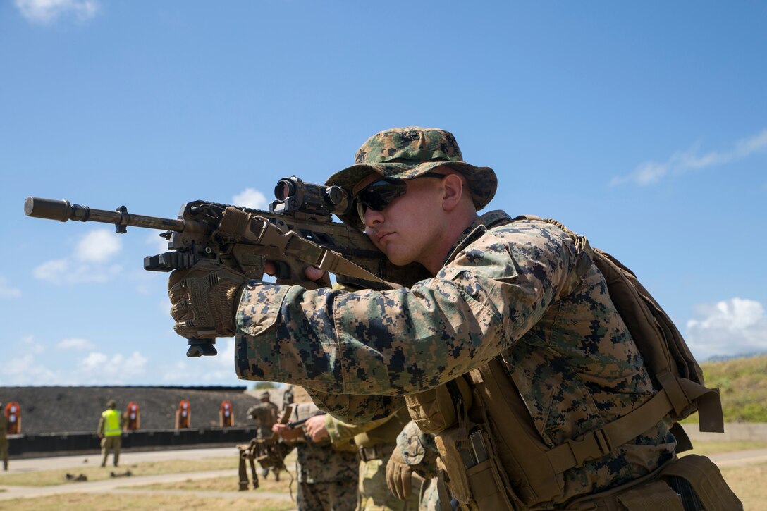 180629-M-FA245-1003 MARINE CORPS BASE HAWAII (June 29, 2018) U.S. Marine Corps Lance Cpl. Jacob Steenweg, a rifleman with Marine Air Ground Task Force-Hawaii, sights in on with an enhanced F88 Austeyr rifle during a live fire training event as part of Rim of the Pacific (RIMPAC) exercise at the Ulupa’u Crater Range Training Facility on Marine Corps Base Hawaii June 29, 2018. RIMPAC provides high-value training for task-organized, highly-capable Marine Air-Ground Task Force and enhances the critical crisis response capability of U.S. Marines in the Pacific. Twenty-five nations, 46 ships, five submarines, about 200 aircraft and 25,000 personnel are participating in RIMPAC from June 27 to Aug. 2 in and around the Hawaiian Islands and Southern California.(U.S. Marine Corps photo by Lance Cpl. Adam Montera)