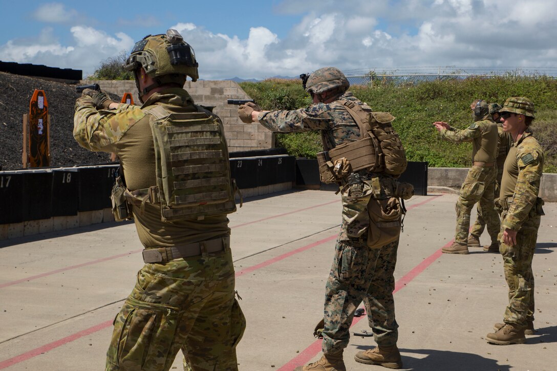 180629-M-FA245-1005 MARINE CORPS BASE HAWAII (June 29, 2018) Australian soldiers and U.S. Marines fire M9 pistols during a live fire training event as part of Rim of the Pacific (RIMPAC) exercise at the Ulupa’u Crater Range Training Facility on Marine Corps Base Hawaii June 29, 2018. RIMPAC provides high-value training for task-organized, highly-capable Marine Air-Ground Task Force and enhances the critical crisis response capability of U.S. Marines in the Pacific. Twenty-five nations, 46 ships, five submarines, about 200 aircraft and 25,000 personnel are participating in RIMPAC from June 27 to Aug. 2 in and around the Hawaiian Islands and Southern California. (U.S. Marine Corps photo by Lance Cpl. Adam Montera)