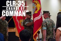 Lt. Col. Kenric D. Stevenson (center), outgoing commanding officer of Combat Logistics Regiment 35, 3rd Marine Logistics Group takes hold of the regimental colors to pass to the incoming commanding officer during a change of command ceremony July 2, 2018 on Camp Kinser, Okinawa, Japan. Stevenson relinquished command of CLR-35 to Col. Joon H. Um. Stevenson is a native of DeRidder, Louisiana. (U.S. Marine Corps photo by Cpl. Joshua S. Pinkney)