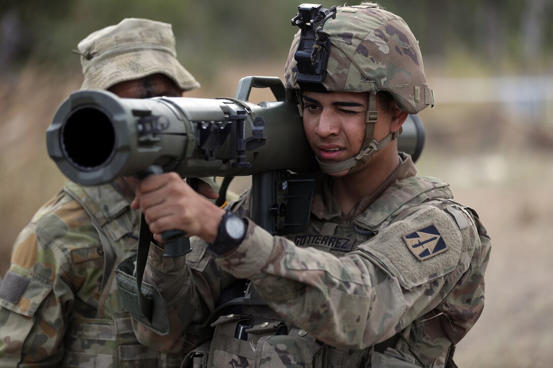 A soldier aims a recoilless rifle.