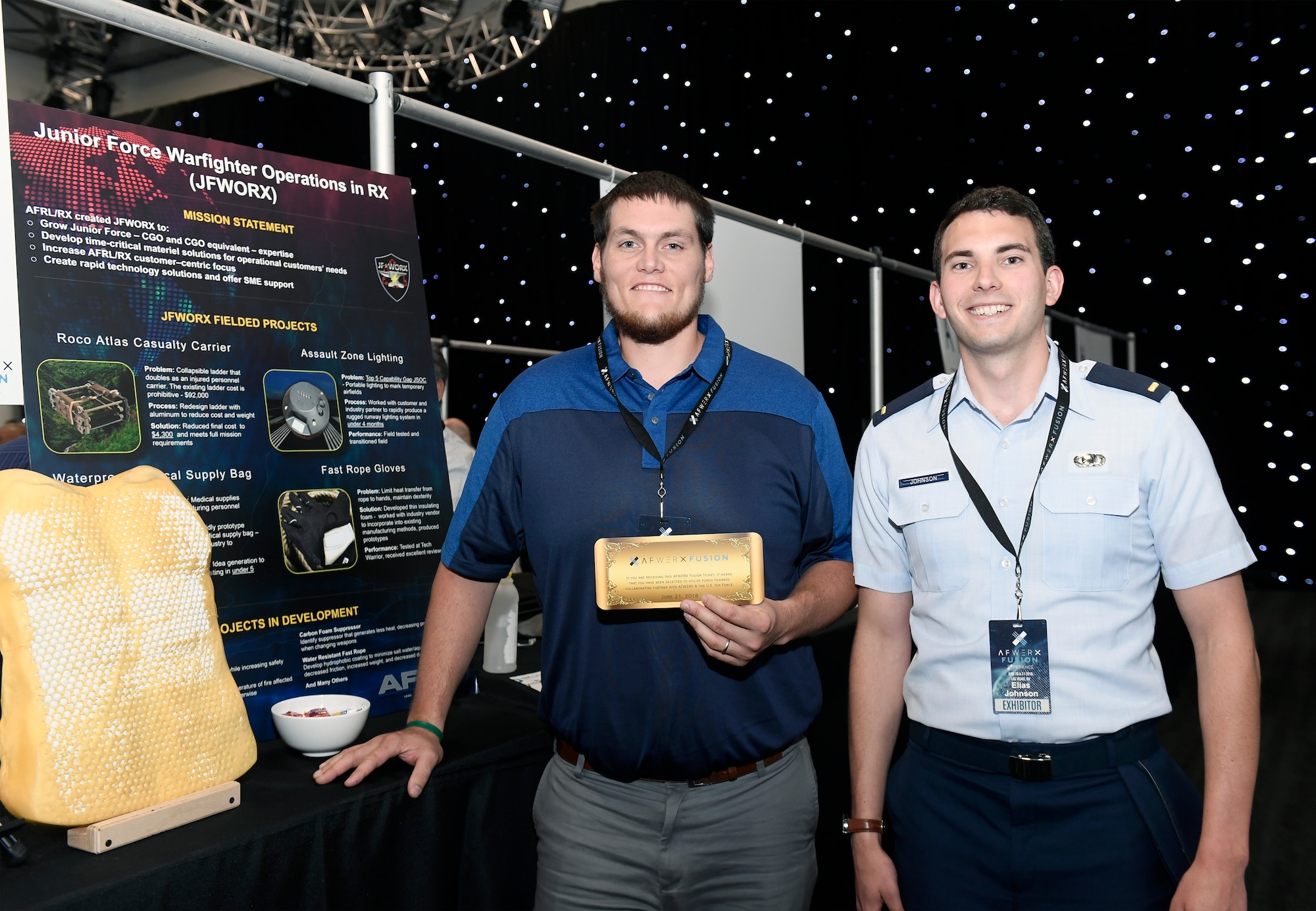 John Bales, a mechanical engineer with AFRL’s Materials and Manufacturing Directorate, and 2nd Lt. Elias Johnson, an AFRL materials research engineer, with their Fusion Ticket inviting them to attend a Fusion Ticket event during the week of July 16 at AFWERX Vegas. Initial startup funding, in the range of $150,000, is up for grabs to further assess the teams' technology at the Fusion Ticket event. They were selected for their Flexible Body Armor technology idea. (AFWERX photo/Bobby Mack)