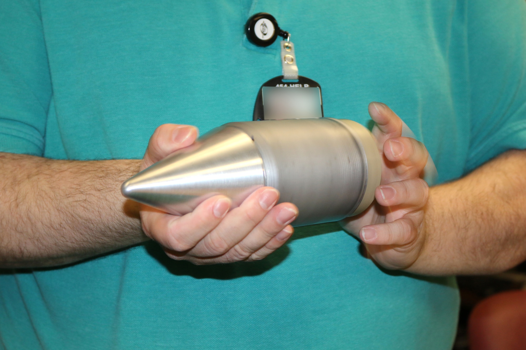 Engineers with the Space and Missiles Combined Test Force at Arnold Air Force Base are developing a telemetry package that will be used to transmit data when launching projectiles at over 25,000 Gs. To accommodate a stand-alone electronics package, an antenna with a detachable radome and multiple integrated sensors, the projectile itself is made up of different parts and materials. Shown are the various parts of the project and then the projectile when totally assembled. (U.S. Air Force photos/Deidre Ortiz) (This image was manipulated by obscuring badges for security purposes)